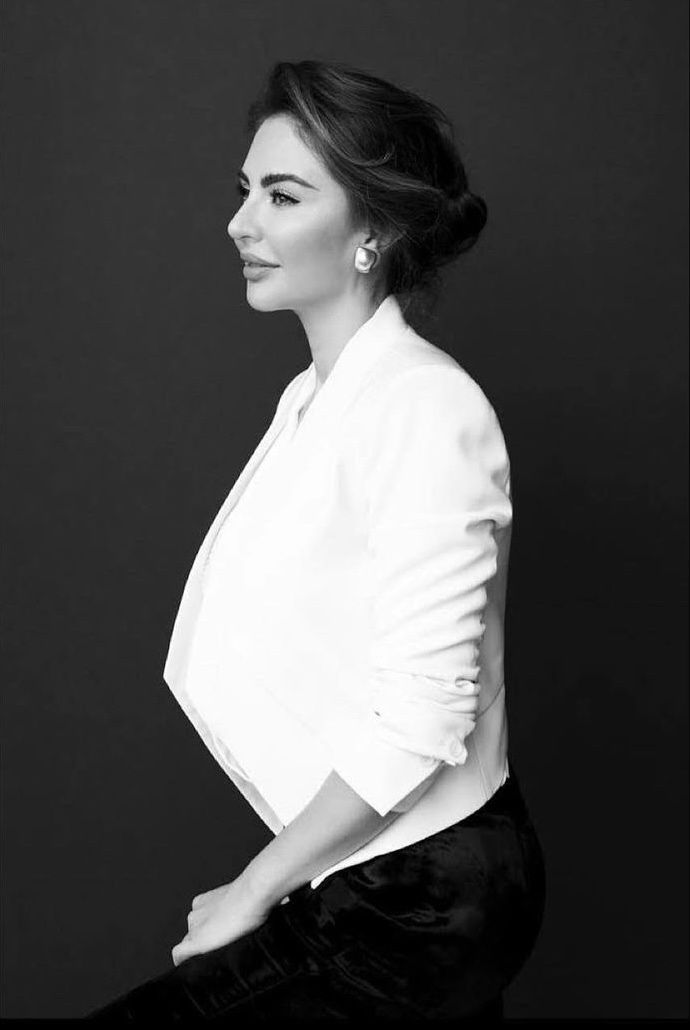 Dayan Candamil in a white jacket, black-and-white portrait from the Hult Prize speaker announcement